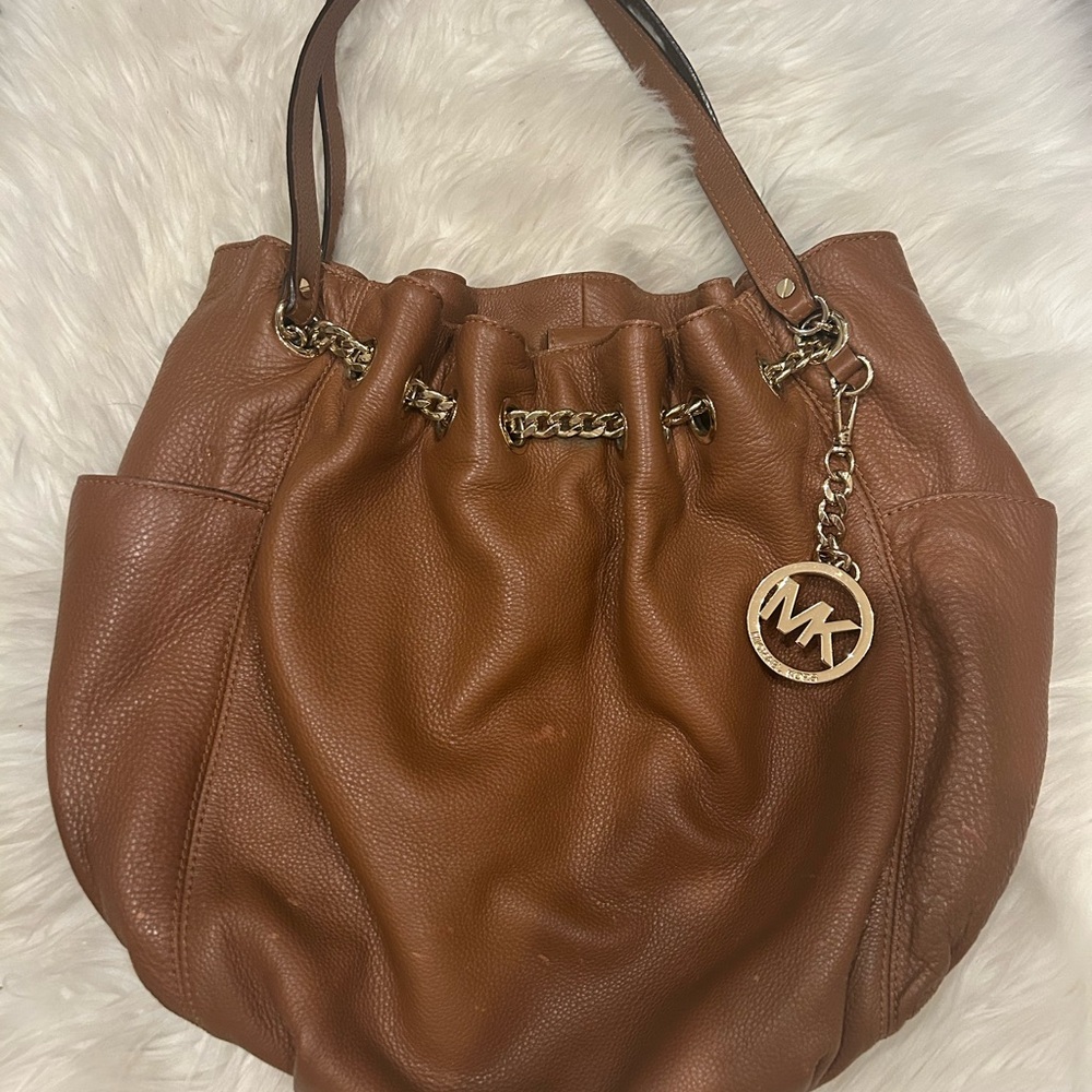 This is a Michael Kors Jet Set Chain O-Ring Tote in pebbled leather. Camel color